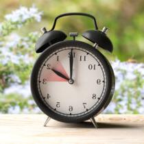 photo of daylight saving time european daylight saving time alarm clock on wooden desk blur spring picture id1128684837