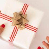 photo of hand holding wrapped gift
